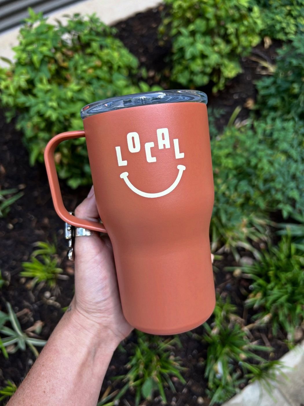 Terracotta Local Coffee tumbler with the smiling LOCAL logo